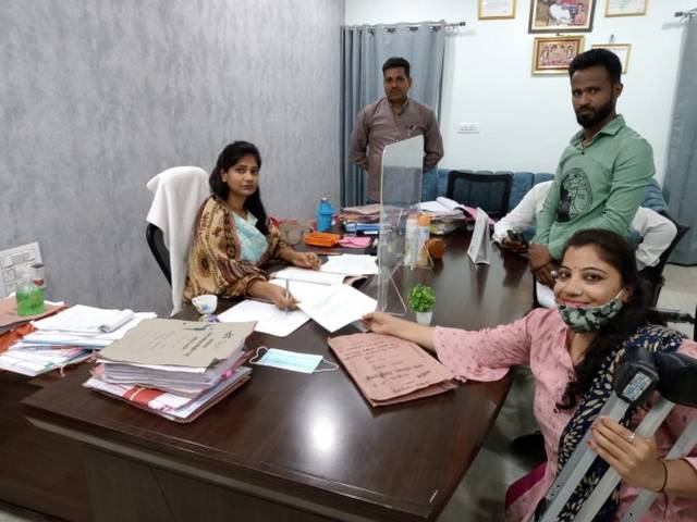 OPD woman leader handing over a letter to the Additional District Collector to form the district-level monitoring committee